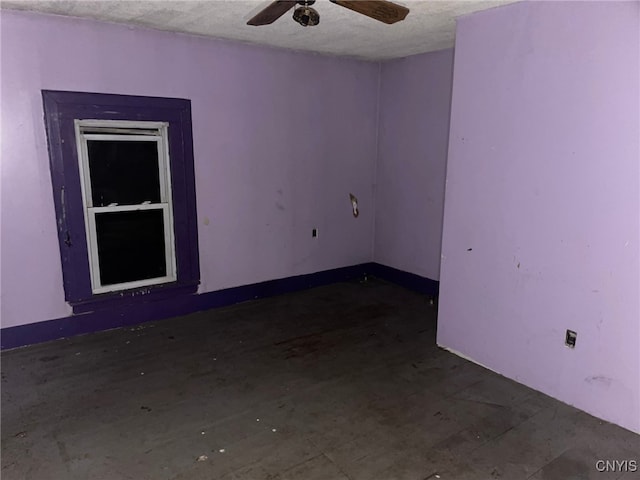 spare room with ceiling fan and a textured ceiling