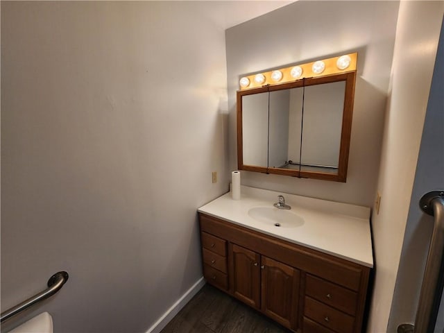 bathroom with hardwood / wood-style floors and vanity