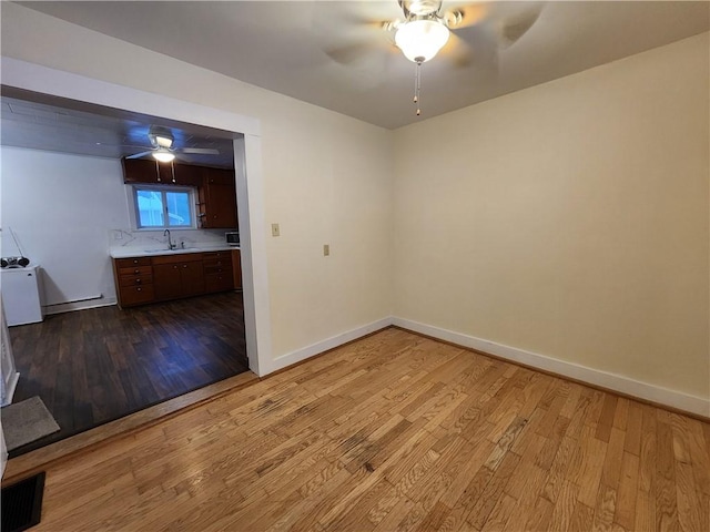 empty room featuring light hardwood / wood-style flooring and sink