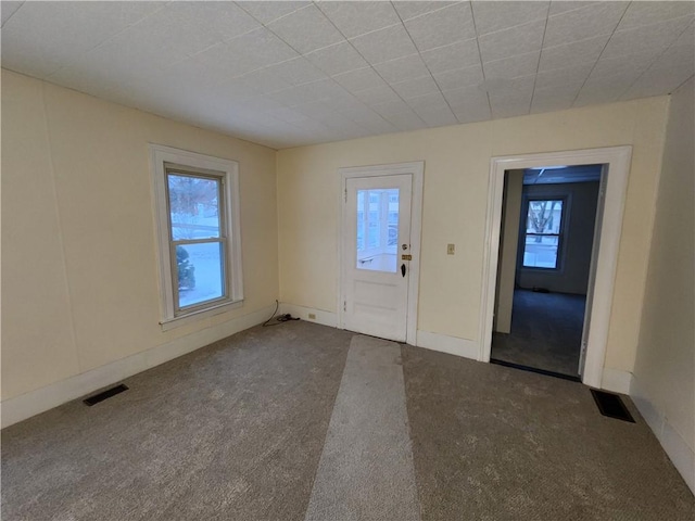 foyer entrance featuring carpet floors