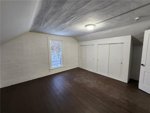 bonus room featuring dark wood-type flooring and lofted ceiling