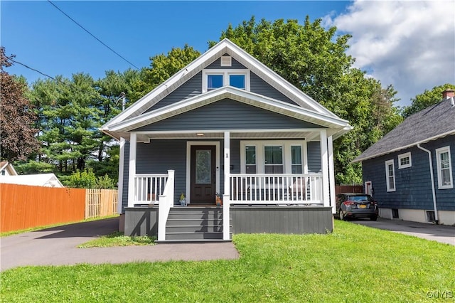 bungalow with a porch and a front yard