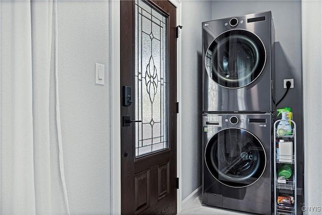 laundry area with stacked washer / drying machine