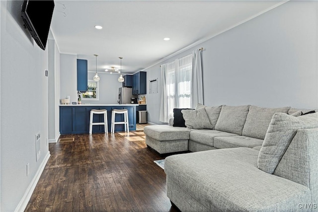 living room with dark wood-type flooring and ornamental molding