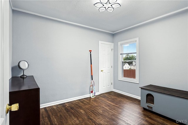 entryway featuring dark hardwood / wood-style floors, crown molding, and a textured ceiling