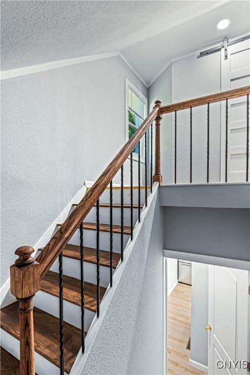 stairs featuring wood-type flooring and vaulted ceiling