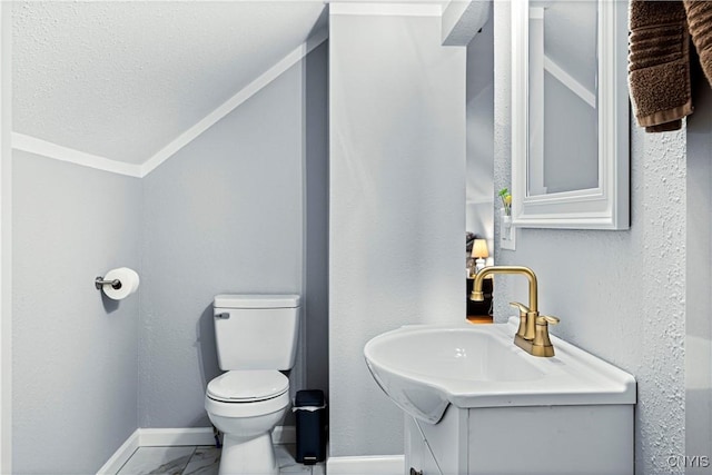 bathroom with vanity, toilet, and ornamental molding