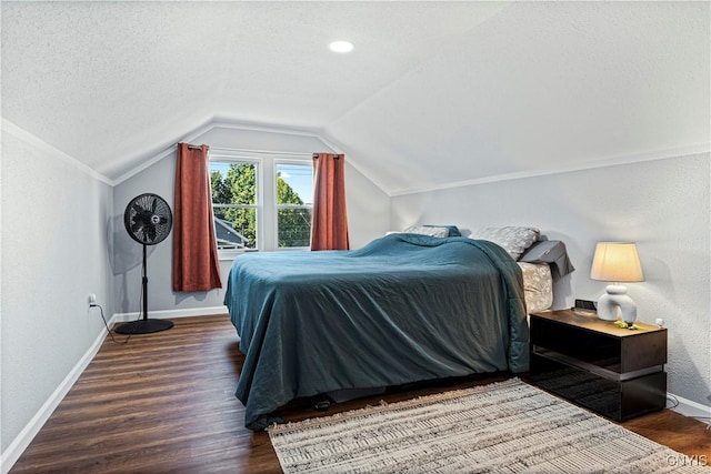 bedroom featuring dark hardwood / wood-style flooring, lofted ceiling, and a textured ceiling