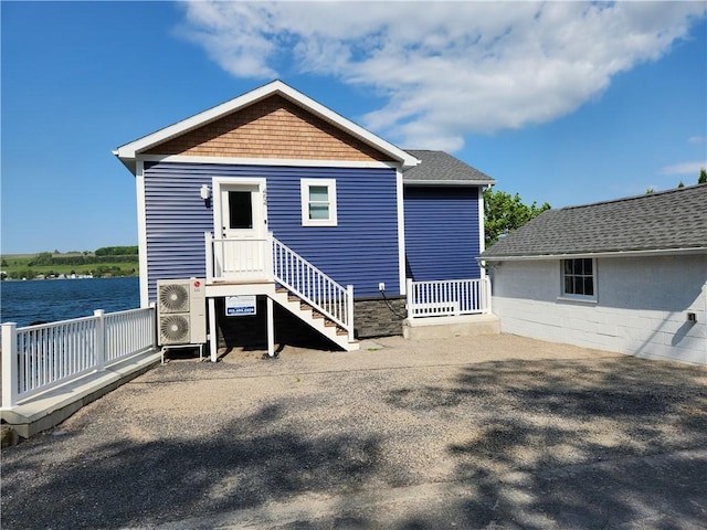 back of house featuring a water view