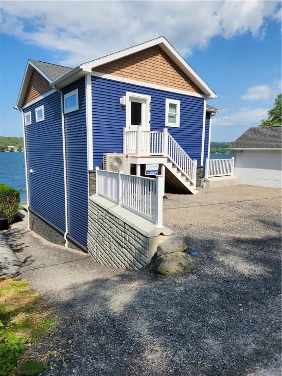 rear view of house featuring a water view