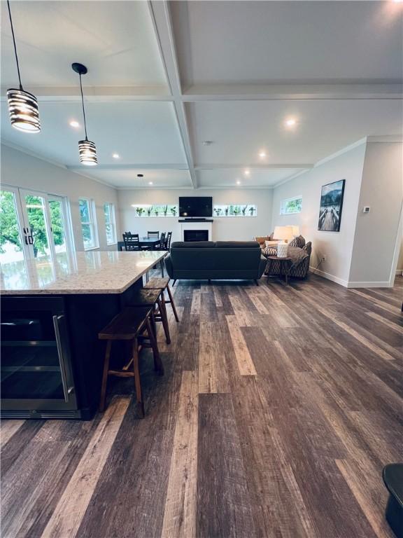 dining space featuring ornamental molding, coffered ceiling, beamed ceiling, dark hardwood / wood-style floors, and wine cooler