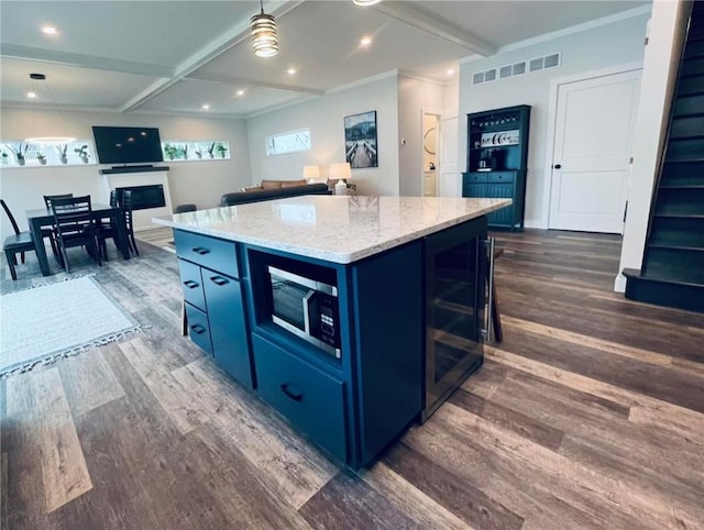 kitchen with beam ceiling, a center island, beverage cooler, dark hardwood / wood-style flooring, and blue cabinets