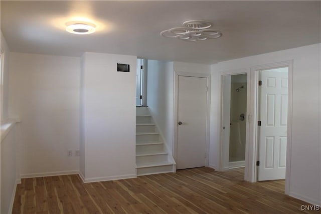 stairs featuring baseboards and wood finished floors