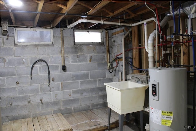 basement with water heater and a sink