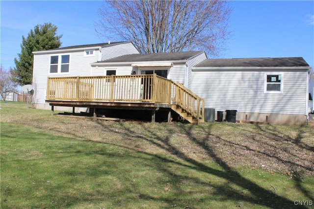 back of property featuring a deck, a lawn, and central air condition unit