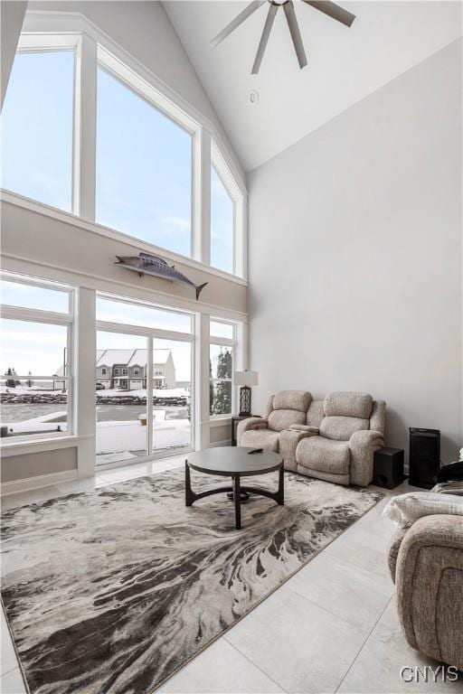 living room with high vaulted ceiling and ceiling fan