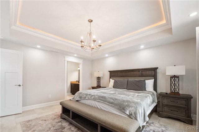 bedroom featuring a notable chandelier, ensuite bath, ornamental molding, and a raised ceiling