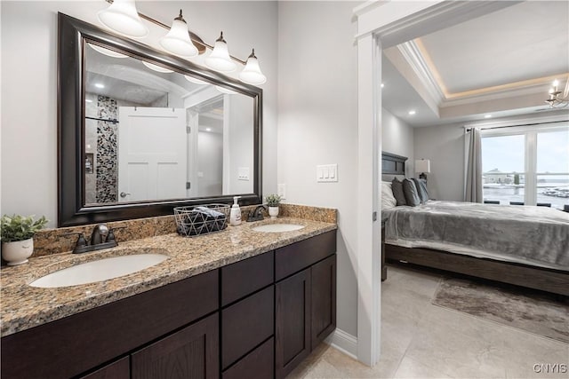 bathroom featuring crown molding, tile patterned floors, vanity, and a tray ceiling