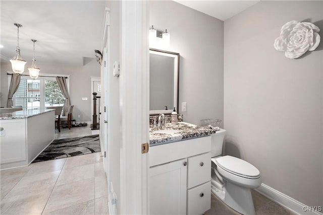 bathroom featuring vanity, tile patterned floors, and toilet