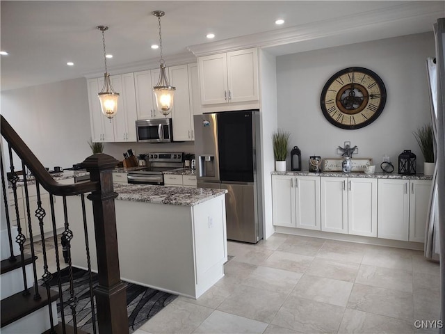 kitchen with white cabinetry, stainless steel appliances, light stone countertops, and hanging light fixtures