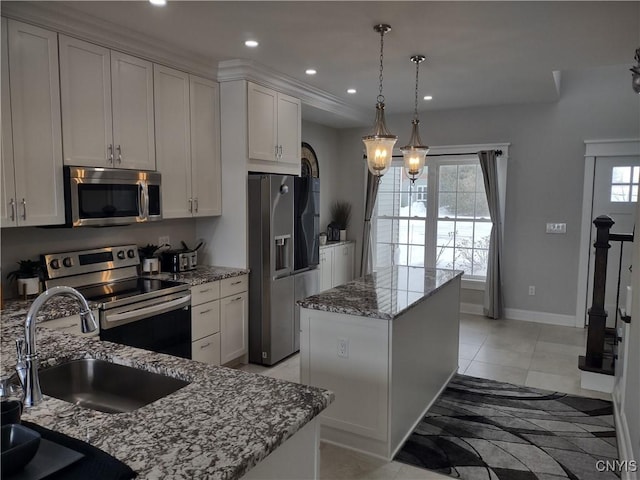 kitchen with sink, light stone counters, a center island with sink, pendant lighting, and stainless steel appliances