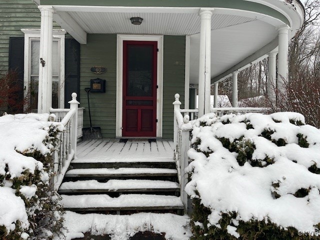 view of snow covered property entrance