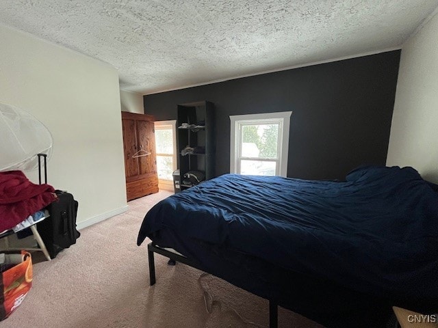 carpeted bedroom featuring a textured ceiling