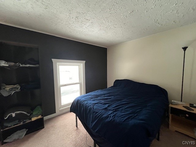 carpeted bedroom featuring a textured ceiling