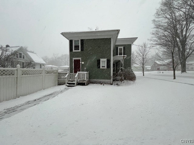 view of snow covered rear of property