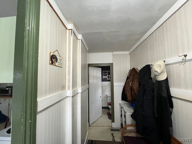 mudroom with a textured ceiling