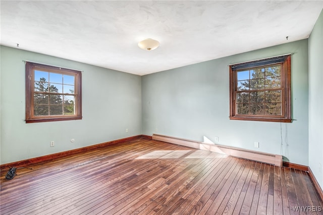 spare room featuring hardwood / wood-style flooring and a baseboard radiator