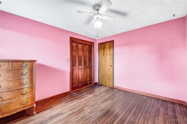 unfurnished bedroom with a closet, light hardwood / wood-style floors, and ceiling fan