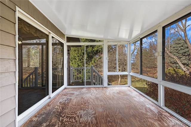 unfurnished sunroom featuring lofted ceiling