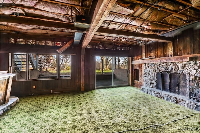 miscellaneous room with carpet and wood walls