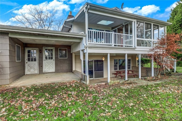 rear view of house with a patio area and a balcony