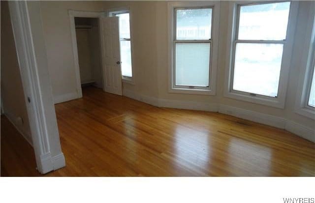 spare room with hardwood / wood-style floors