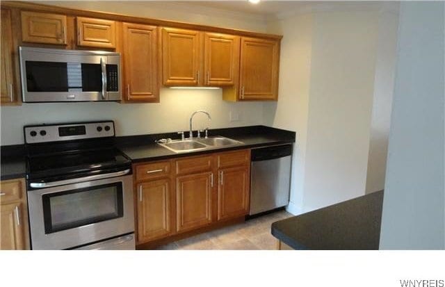 kitchen with sink and appliances with stainless steel finishes