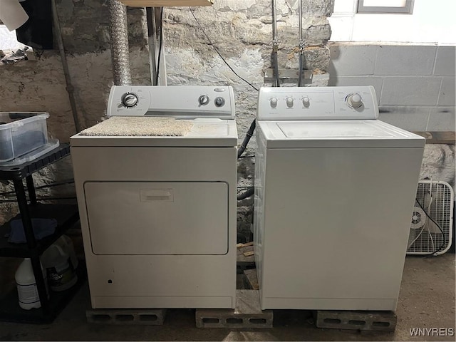 clothes washing area featuring washer and clothes dryer