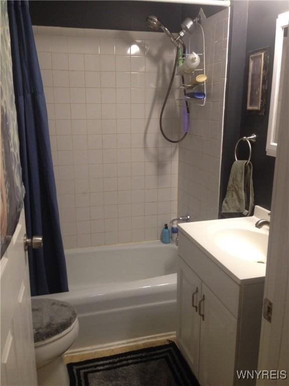 full bathroom with vanity, toilet, and shower / bath combo with shower curtain