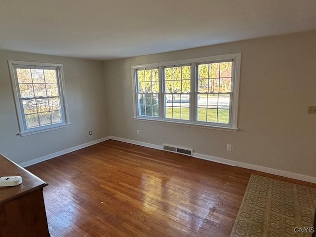 spare room featuring dark hardwood / wood-style floors