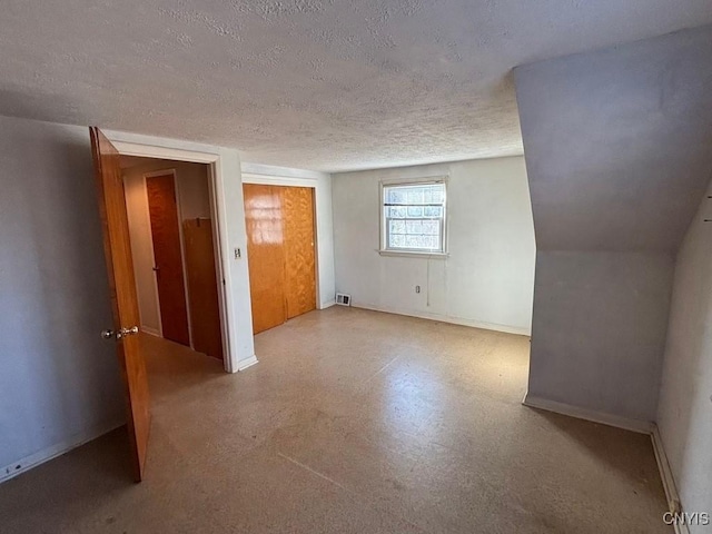 unfurnished room featuring a textured ceiling