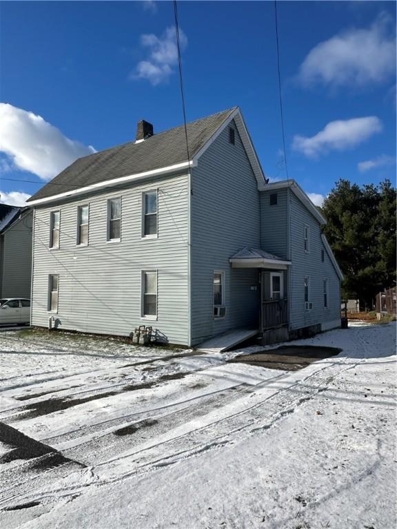 view of snow covered rear of property