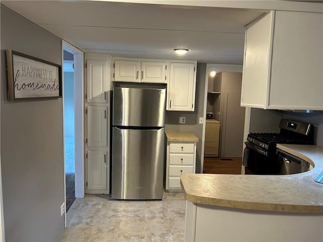 kitchen with white cabinets and appliances with stainless steel finishes