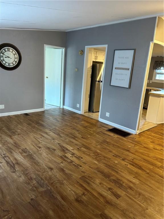 interior space with crown molding and hardwood / wood-style flooring