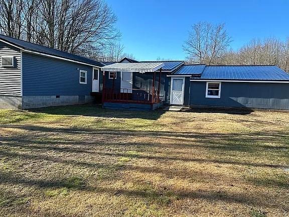 rear view of property with a lawn