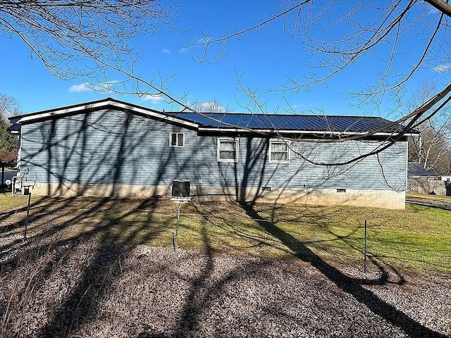 view of home's exterior featuring central air condition unit and a yard