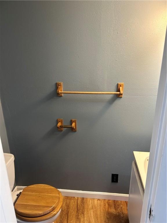 bathroom featuring hardwood / wood-style flooring and toilet