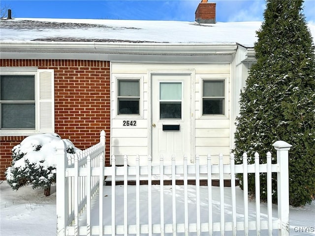 view of snow covered property entrance