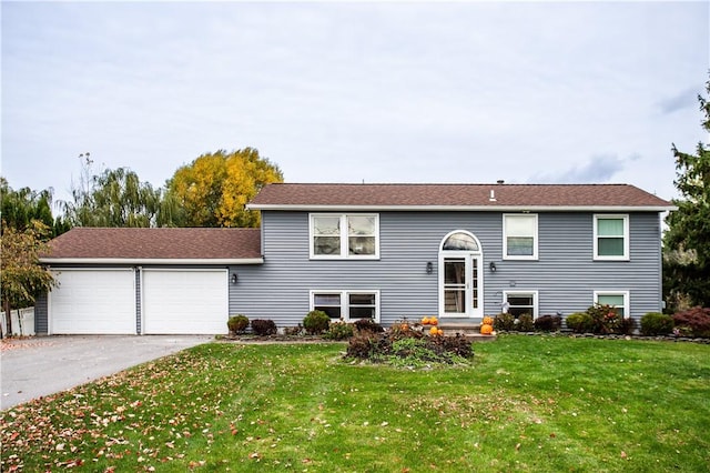 raised ranch featuring a garage and a front yard