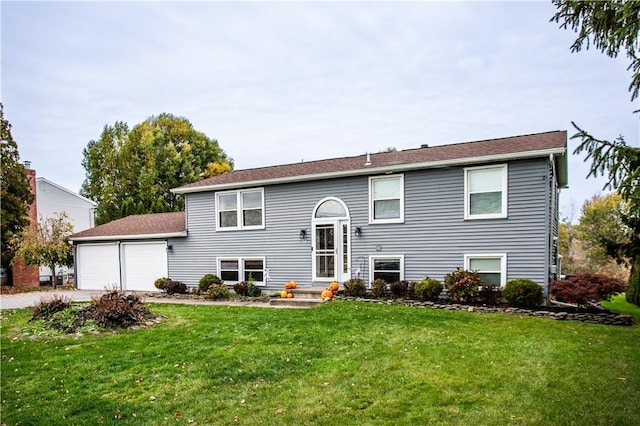 split foyer home featuring a garage and a front lawn